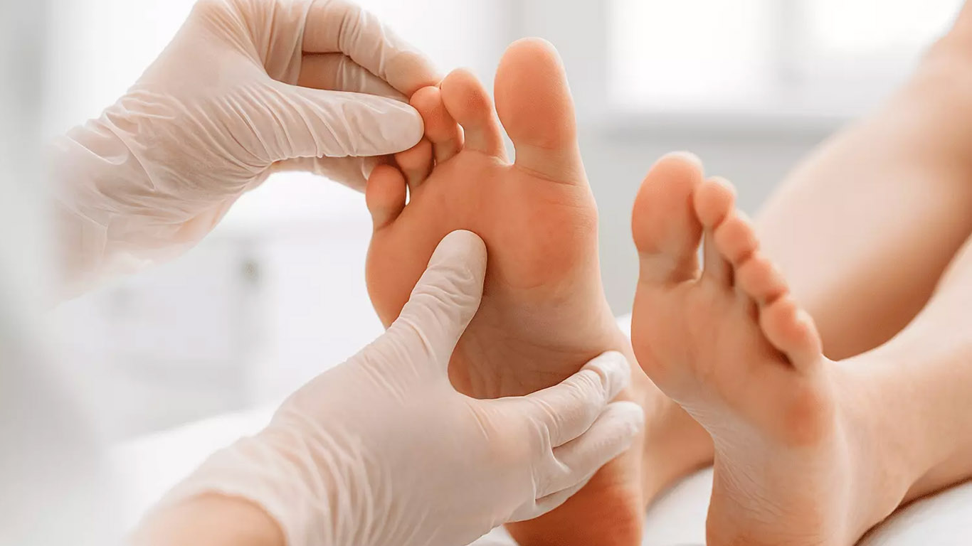 A podiatrist is examining a patient.