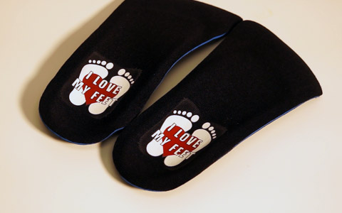 A closeup of the black pair of custom orthotics.