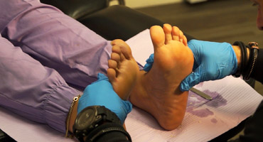 Dr. Mitchell Wacthel examines and assesses a patient's plantar fasciitis.